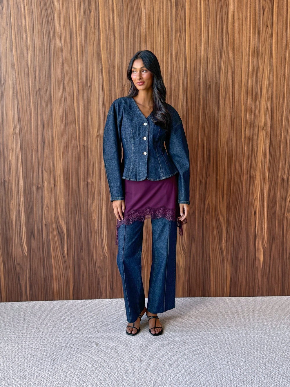Fitted denim jacket with balloon sleeves over a berry red lace-trim singlet and front seam jeans.